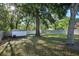 Large backyard with a storage shed, shade trees, and a privacy fence at 30236 Pga Dr, Sorrento, FL 32776