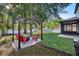 Backyard featuring a pergola with seating, a firepit, and a well-manicured lawn at 30236 Pga Dr, Sorrento, FL 32776