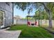 Inviting backyard featuring a pergola with red Adirondack chairs and a lush lawn at 30236 Pga Dr, Sorrento, FL 32776