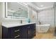 Elegant bathroom featuring a modern vanity with gold accents, a soaking tub, and white marble-look tile at 30236 Pga Dr, Sorrento, FL 32776