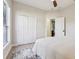 Bright bedroom featuring a ceiling fan, light wood floors, and a double door closet for plenty of storage at 30236 Pga Dr, Sorrento, FL 32776
