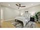 Comfortable bedroom with ceiling fan, wood-look floors, and a well-lit atmosphere at 30236 Pga Dr, Sorrento, FL 32776