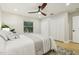 Bedroom features a ceiling fan, wood-look floors, and double closets for ample storage space at 30236 Pga Dr, Sorrento, FL 32776