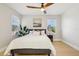 Bedroom featuring ceiling fan, light wood floors, and window letting in natural light at 30236 Pga Dr, Sorrento, FL 32776