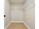 Small walk-in closet with laminate flooring and wire shelves at 30236 Pga Dr, Sorrento, FL 32776