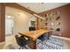 Elegant dining room with a unique wood table, modern light, and access to the kitchen at 30236 Pga Dr, Sorrento, FL 32776