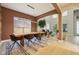 Spacious dining room featuring a large wooden table, modern lighting, and view into the living room at 30236 Pga Dr, Sorrento, FL 32776
