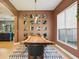 Unique dining room showcasing a natural wood table, modern light fixture, and gallery wall at 30236 Pga Dr, Sorrento, FL 32776