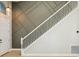 Entryway with high ceilings, decorative wall panels, a white staircase, and light wood floors at 30236 Pga Dr, Sorrento, FL 32776