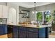 Kitchen with center island and bar seating, opens to the living area at 30236 Pga Dr, Sorrento, FL 32776