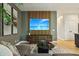 Contemporary living room with modern entertainment center and ocean-themed wall art at 30236 Pga Dr, Sorrento, FL 32776