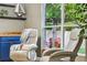 Sitting area with comfortable chairs, next to a bar area and large window at 30236 Pga Dr, Sorrento, FL 32776