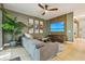 Comfortable living room with gray sofa, wood-look flooring, and a view of the entry hall at 30236 Pga Dr, Sorrento, FL 32776