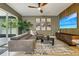 Modern living room featuring a plush gray sofa, stylish rug, and contemporary entertainment center at 30236 Pga Dr, Sorrento, FL 32776