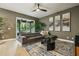 Well-lit living room with a large sectional sofa, rug, and sliding doors to the patio at 30236 Pga Dr, Sorrento, FL 32776