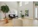 Spacious living room with high ceilings, light wood floors, and large windows for natural light at 30236 Pga Dr, Sorrento, FL 32776