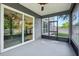 Screened-in porch showcasing backyard views, ceiling fan, and sliding glass door into the home at 30236 Pga Dr, Sorrento, FL 32776