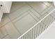 Staircase featuring painted wood, decorative wall paneling, and white railings at 30236 Pga Dr, Sorrento, FL 32776