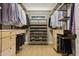 Organized walk-in closet with drawers, shelves, hanging racks, and a window, providing ample storage space at 30236 Pga Dr, Sorrento, FL 32776
