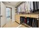 Well-organized walk-in closet featuring custom shelves, drawers, and hanging rods with view to bathroom at 30236 Pga Dr, Sorrento, FL 32776