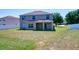 Spacious backyard featuring a covered patio, surrounded by a white fence at 307 Big Black Ln, Poinciana, FL 34759