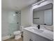 Bright bathroom with glass shower, modern fixtures, and sleek quartz countertop at 307 Big Black Ln, Poinciana, FL 34759