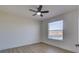 Neutral bedroom featuring a ceiling fan and a window overlooking the neighborhood at 307 Big Black Ln, Poinciana, FL 34759