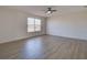 A sunlit bedroom with wood-look floors and a modern fan creates an airy and inviting space at 307 Big Black Ln, Poinciana, FL 34759