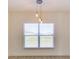 Contemporary dining area illuminated by pendant lights, showcasing neutral walls and a bright window view at 307 Big Black Ln, Poinciana, FL 34759