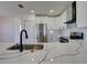 Modern kitchen featuring a quartz countertop, stainless steel appliances, and white cabinetry at 307 Big Black Ln, Poinciana, FL 34759