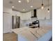 Bright kitchen featuring modern stainless steel appliances, white cabinetry, and large quartz countertops at 307 Big Black Ln, Poinciana, FL 34759