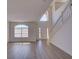 Bright, open-concept living room features lots of natural light and hardwood floors at 307 Big Black Ln, Poinciana, FL 34759
