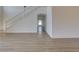 Bright living room featuring hardwood flooring, and staircase at 307 Big Black Ln, Poinciana, FL 34759
