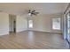Open-concept living room with neutral walls, wood-look floors and bright natural light at 307 Big Black Ln, Poinciana, FL 34759