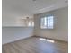 Upstairs loft area featuring wood-look floors and a window at 307 Big Black Ln, Poinciana, FL 34759