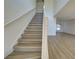 A bright staircase ascends to the upper level, with a spacious open living area visible beyond at 307 Big Black Ln, Poinciana, FL 34759