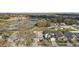 Aerial view of homes in a suburban neighborhood near a lake at 308 Anorak St, Groveland, FL 34736