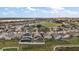 Aerial view of homes in a suburban neighborhood near a lake at 308 Anorak St, Groveland, FL 34736