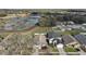 An aerial view of a home near a pond, showcasing the community and surrounding landscape at 308 Anorak St, Groveland, FL 34736