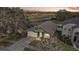 Aerial view of a grey house with a two car garage at 308 Anorak St, Groveland, FL 34736