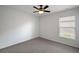 Bedroom with a ceiling fan, neutral carpet, and a window at 308 Anorak St, Groveland, FL 34736