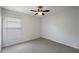 Bedroom with a ceiling fan, neutral carpet, and a window at 308 Anorak St, Groveland, FL 34736