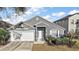Charming single Gathering home featuring well-maintained landscaping and an attached two-car garage at 308 Anorak St, Groveland, FL 34736