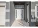 Close-up of the front entrance with a white door, sidelights, and transom window at 308 Anorak St, Groveland, FL 34736