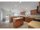 Open kitchen featuring an island, tile floors and plenty of cabinet space at 308 Anorak St, Groveland, FL 34736