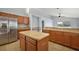 Open kitchen featuring a stainless steel refrigerator, ample counter space, wooden cabinets, and a view to the backyard at 308 Anorak St, Groveland, FL 34736