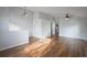 Open-concept living area featuring hardwood floors and neutral color palette at 308 Anorak St, Groveland, FL 34736