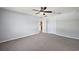 Spacious main bedroom offering a ceiling fan, carpet flooring, and neutral paint at 308 Anorak St, Groveland, FL 34736