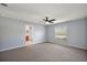 Large main bedroom with carpeting, a ceiling fan, natural light, and ensuite bathroom at 308 Anorak St, Groveland, FL 34736