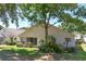 The backyard offers ample space with lush greenery, mature trees, and a partially screened patio at 3785 Avon Ct, Clermont, FL 34711